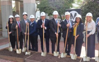 9 People holding shovels at a groundbreaking